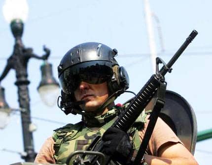 Army Manual Outlines Plan To Kill Rioters, Demonstrators In America New Orleans Katrina military police patrol Canal St. 090505 by AP