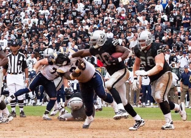 Raiders-RB-Darren-McFadden-stiff-armed-by-Rams-DE-James-Hall-091910-by-Roberto-Daza-OaklandNorth.net_, Raiders find a way over Rams 16-14, Culture Currents 