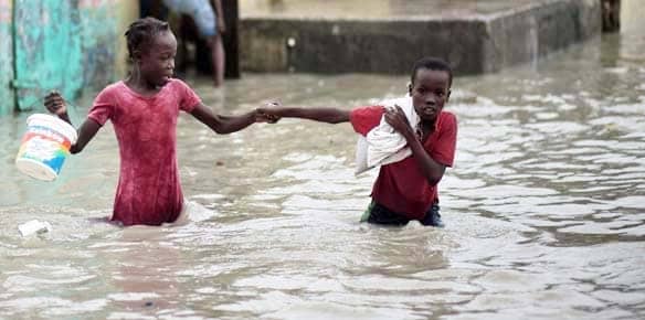 Haiti-Hurricane-Tomas-children-cross-flooded-street-Cite-Soleil-by-Ramon-Espinosa-AP3, Flooding intensifies cholera outbreak in Haiti, World News & Views 