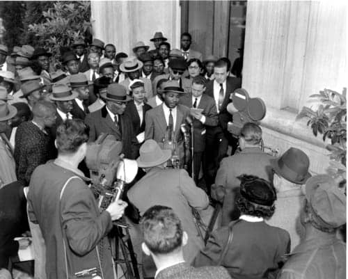 Martin-Luther-King-speaks-to-press-after-arrest-for-Montgomery-bus-boycott-1956-by-Gene-Herrick-AP, Dr. King and the 1955-1956 Montgomery bus boycott, News & Views 