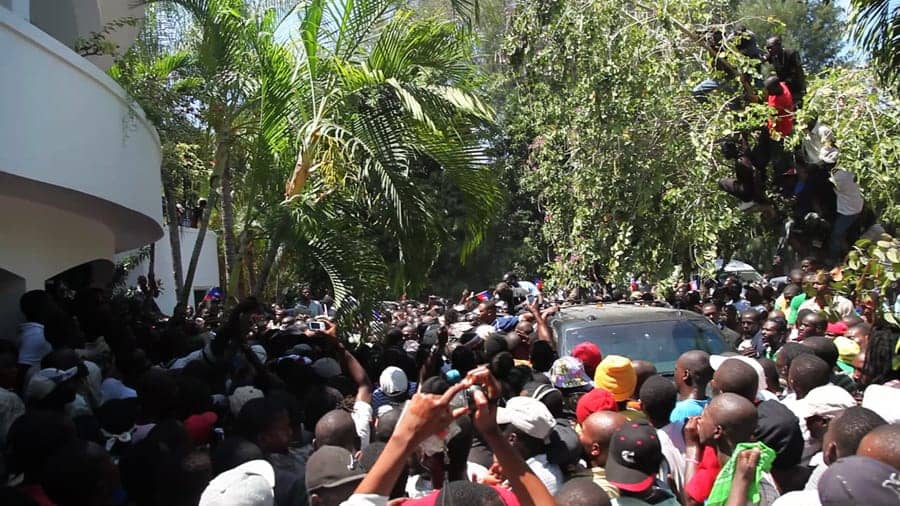 Haiti-Aristide’s-return-home-car-surrounded-031811-by-Paul-Burke1, Joyous victory in a bitter time: Haiti before and after Aristide’s return, World News & Views 