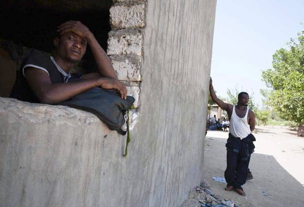 Black-migrant-workers-hiding-Libyan-farm-0911-by-Giulio-Petrocco-AP, U.S.-NATO robbing Africa at gunpoint, World News & Views 