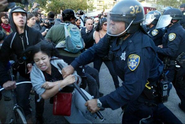 Occupy-Oakland-v.-cops-Black-woman-attacked-102511-by-Ray-Chavez-Contra-Costa-Times, The police raid on Occupy Oakland was nothing new for this city, Local News & Views 