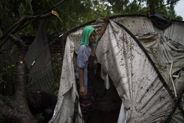 Woman-tries-to-re-erect-tent-after-rainstorm-Port-au-Prince-Haiti-092410-by-AP, Report from Haiti: Where’s the money?, World News & Views 