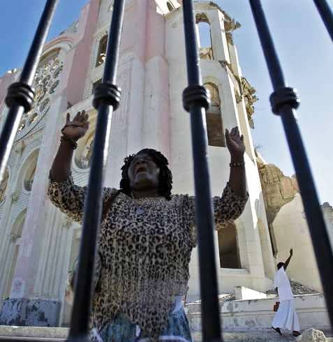 Woman-prays-at-Notre-Dame-National-Cathedral-still-heavily-damaged-2nd-earthquake-anniv.-PAP-011212-by-Carl-Juste-Miami-Herald, Haiti: Seven places where the earthquake money did and did not go, World News & Views 