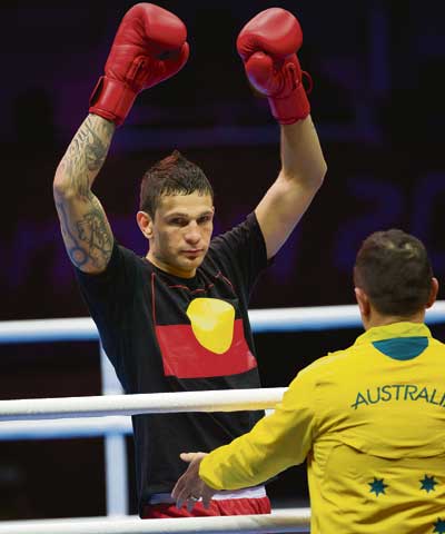 Damien-Hooper-wears-Aboriginal-flag-T-shirt-in-Olympic-ring-073012-by-Jason-South, Damien Hooper: The sanctioning of an anti-racist Olympic rebel, Culture Currents 