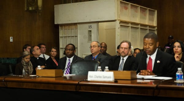 Panel_w_Dir._of_FBOP_Charles_Samuels_Jr._at_mic_mock_solitary_cell_by_ACLU_at_Senate_hearing_061912_by_Jonathan_Ernst_NYT1, Solitary confinement: Torture chambers for Black revolutionaries, Behind Enemy Lines 