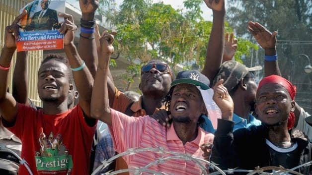 Haitians-march-support-Aristide-oppose-Martelly-PAP-022912, Resistance to Martelly regime grows in Haiti, World News & Views 