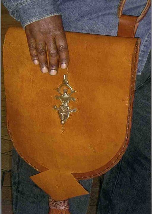 Shaka-Camera-hand-tooled-leather-bag, Pan African designs adorn leatherworker Shaka Camera’s hand tooled bags at the KPFA Crafts Fair, Culture Currents 
