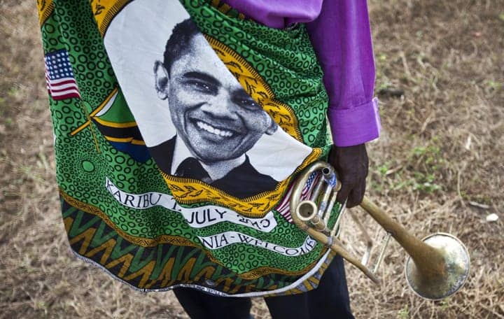 Obama’s-face-adorns-brass-band-member-welcoming-Obama-at-Dar-es-Salaam-State-House-for-meeting-with-Tanzanian-President-Jakaya-Kitwete-070113-by-Ben-Curtis-AP, In Tanzania, did Obama call out ‘Congo’s neighbors’ strongly enough to bring peace to the Congo?, World News & Views 
