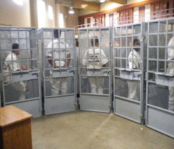 Prisoners in cages await group therapy, Mule Creek State Prison, photo from U.S. District Court briefings