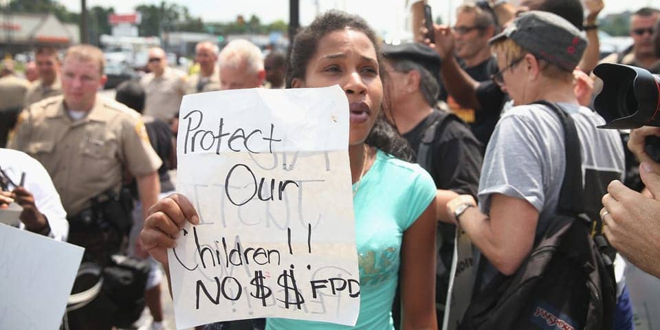 Michael-Brown-rebellion-Protect-our-children-No-for-FPD-cops-media-081814-by-Scott-Olson, The lessons of Ferguson, Part One: Economic inequality a root cause of unrest, News & Views 