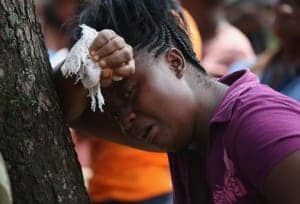 Liberian-woman-Korpo-Klay-watches-burial-team-take-deceased-cousin-Kormassa-Kaba-dead-of-Ebola-300x204, Ebola, the African Union and bioeconomic warfare, World News & Views 