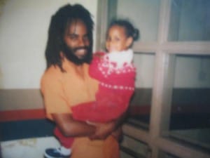 Mumia-holds-lil-daughter-Goldii-300x225, Oct. 14 take action to stop Pennsylvania’s ‘Gag Mumia and All Other Prisoners’ bill, News & Views 