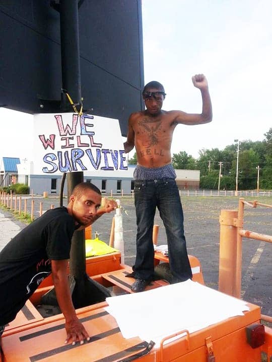 Michael-Brown-rebellion-We-will-survive-JRs-guide-on-left-082214-Ferguson-by-JR-BR, From the front lines in Ferguson: ‘We will go out hard’, News & Views 