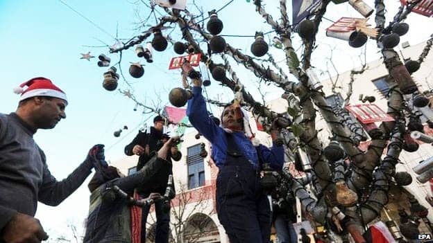 Activists-decorate-tree-in-Manger-Square-with-empty-tear-gas-grenades-122414-by-EPA, If Mary and Joseph tried to reach Bethlehem today, they would get stuck at an Israeli checkpoint, World News & Views 