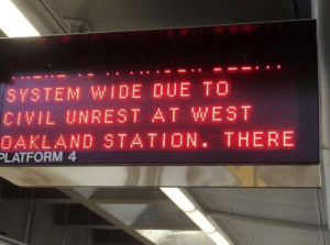 Black-Lives-Matter-West-Oakland-BART-shut-down-both-ways-112814-5-by-Alicia-Garza-300x223, Blackout Collective obstructs BART trains on Black Friday in protest of police killings, Local News & Views 