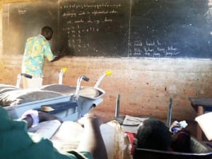 Eunice-Atim-in-school-with-both-wheelbarrow-wheelchair-from-her-perspective-1214-by-Ronald-Galiwango-300x225, Wheelchair mobility plus education equals a bright future for Eunice Atim of Uganda, World News & Views 