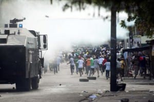 Haitians-flee-water-cannon-protest-against-Martelly-Port-au-Prince-011015-by-Hector-Retamal-AFP-300x199, Five years later: Haitians step up their fight for independence and democracy, World News & Views 