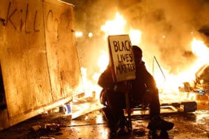 Black-Lives-Matter’-protester-street-fire-Oakland-112414-by-Stephen-Lam-Reuters-300x200, If Black lives matter - A message to the youth from behind enemy lines, Abolition Now! 