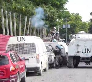 UN-vs.-Haitians-guns-vs.-rocks-1214-300x267, With general strikes and marches, Haitians demand government by the people, World News & Views 