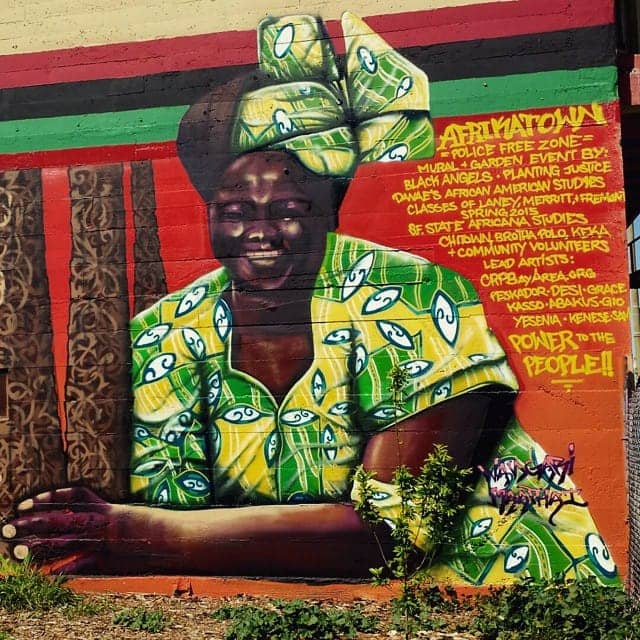 AfrikaTown-mural-Nigerian-woman-message, Cultivating resistance in AfrikaTown, West Oakland, Local News & Views 