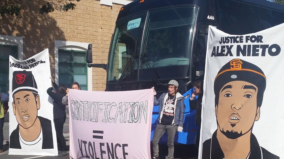 Alex-Nieto-1st-SFPD-murder-anniv-eBay-bus-blocked-Gentrification-Violence-held-by-Erin-MC-Anti-Eviction-Mapping-Project-Amilcar-Perez-Alex-Nieto-Mission-Police-Stn-032315-by-PNN, California: For rich people only?, News & Views 