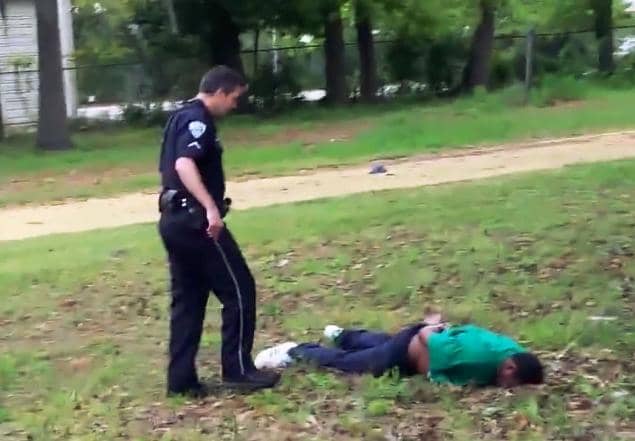 South-Carolina-cop-Michael-Slager-33-checks-Walter-Scott-50-after-shooting-him-040415, White cop charged with murder for shooting Black man in South Carolina, News & Views 