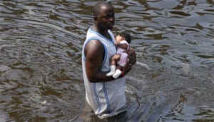 Man-carries-baby-after-Superdome-evacuated-post-Katrina-by-US-Navy-300x172, ‘Katrina: After the Flood’, News & Views 