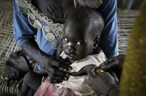 South-Sudan-mother-holds-child-being-treated-300x199, South Sudan: African Union commission says oil resources must benefit the people for lasting peace, World News & Views 