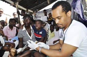 Haiti-earthquake-JRs-Team-Dr.-Chris-Zamani-treats-boys-injured-leg-0210-by-Siraj-web-300x199, Bay Area Black doctor plans to repatriate to South Africa, World News & Views 