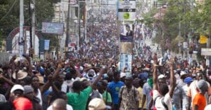 Port-au-Prince-protesters-march-after-forcing-postponement-of-012416-runoff-election-012216-by-Dieu-Nalio-Chery-AP-300x157, Haiti rises: a time for solidarity, World News & Views 