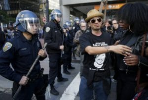 Super-Bowl-City-Grand-Opening-Protest-March-Union-Sq-to-Mkt-to-Main-Off.-Joshua-Cabillo-shoves-Deja-Caldwell-013016-by-Paul-Chinn-SF-Chronicle-300x202, Rhetoric vs. reality: SFPD’s investment in police brutality, Local News & Views 
