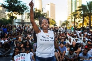 Ethiopian-Israelis-protest-police-terror-Inbar-Bugala-fronts-highway-sit-in-070316-by-Benny-Woodoo-300x199, Ethiopians protest in Israel, call for end to state racism and police violence, World News & Views 