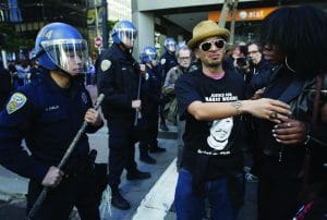 Super-Bowl-City-Grand-Opening-Protest-March-Union-Sq-to-Mkt-to-Main-Off.-Joshua-Cabillo-shoves-Deja-Caldwell-013016-by-Paul-Chinn-SF-Chronicle-300x202, The ‘fundamentalism’ in police operations, Local News & Views 