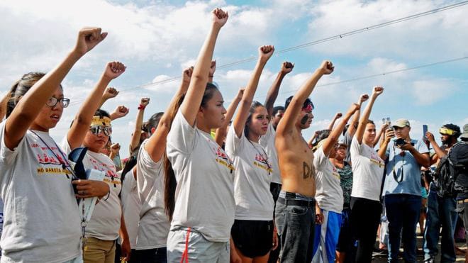 Dakota-Access-Pipeline-protest-youth-fists-up-0916-by-BBC, Lakota women call on President Obama to stop violence by Dakota Access Pipeline, News & Views 
