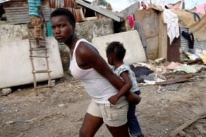 Hurricane-Matthew-young-woman-carries-child-in-Jeremie-Haiti-100716-by-Carlos-Garcia-Rawlins-Reuters-300x200, Haiti needs us now! Donating to the Haiti Emergency Relief Fund (HERF) puts every dime in Haitian hands, World News & Views 