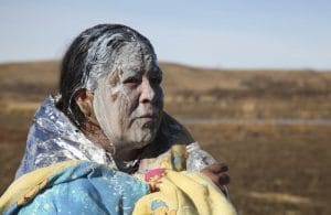 Standing-Rock-old-woman-water-protector-swam-creek-pepper-sprayed-recovers-110216-by-John-Mone-AP-300x195, Standing Rock: Water cannons fired at water protectors in freezing temperatures injure hundreds, News & Views 
