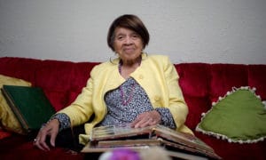 Iris-Canada-on-her-couch-with-books-of-photos-by-Josh-Edelson-Guardian-web-300x180, A loving farewell to Iris Canada, 100 years of Black herstory killed by capitalism, Local News & Views 