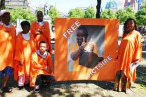 Sit-in-to-free-Victoire-son-Remy-Ndizeye-Niyigena-kneeling-0317-The-Hague-Netherlands-300x200, Rwanda fails to answer Victoire Ingabire’s appeal, World News & Views 