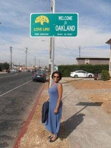 Playwright-actor-Margo-Hall-at-newly-installed-‘Love-Life-Welcome-to-Oakland’-sign-108th-Bancroft-1017-by-Jahahara-web-225x300, Can the military do some good?, Culture Currents 