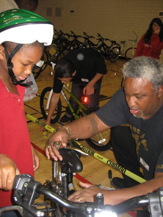 All-of-Us-or-None-13th-Annual-Community-Giveback-Jerry-Elster-adjusts-bike-120812, Children receive gifts from loved ones behind bars at Community Giveback, Local News & Views 