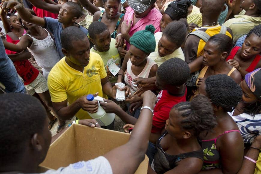 Haitians-in-IDP-camp-Port-au-Prince-get-bleach-water-purification-tablets-to-prevent-cholera-121112-by-Logan-Abassi-UN, UN capitalizing on cholera, playing both arsonist and fireman, World News & Views 