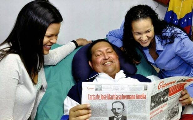 Hugo-Chavez-daughters-in-Cuba-hospital-reading-Granma-021413-1-by-Prensa-Presidencial, First images released of Venezuelan President Chavez since his operation, World News & Views 