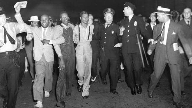 Two-of-9-Scottsboro-Boys-freed-arrive-Penn-Station-NYC-Olen-Montgomery-glasses-Eugene-Williams-suspenders-072637-by-AP, Scottsboro Boys pardoned: What other infamous civil rights cases are in need of closure?, News & Views 