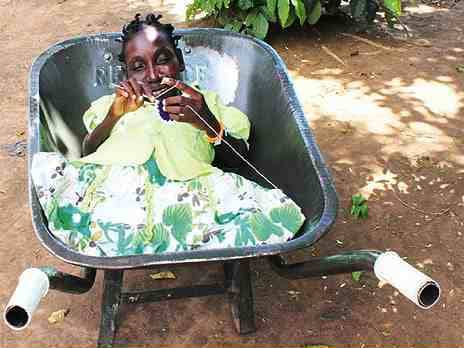 Ekolu-pushing-his-daughter-Atim-in-her-wheelbarrow, Disabled and riding a wheelbarrow: a father’s love, World News & Views 