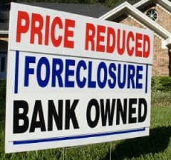 Price-Reduced-Foreclosure-Bank-Owned-sign-on-lawn, Using city power to prevent foreclosure, Local News & Views 