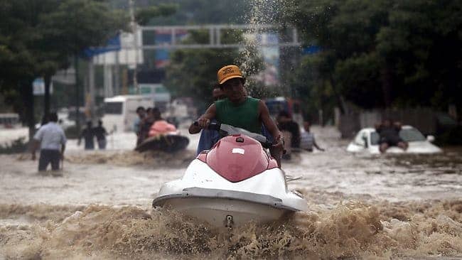 Acapulco-Mexico-floods-jet-ski-transport-091613-by-Pedro-Pardo-AFP, Cholera spreads beyond Haiti as Mexico suffers devastating floods, World News & Views 
