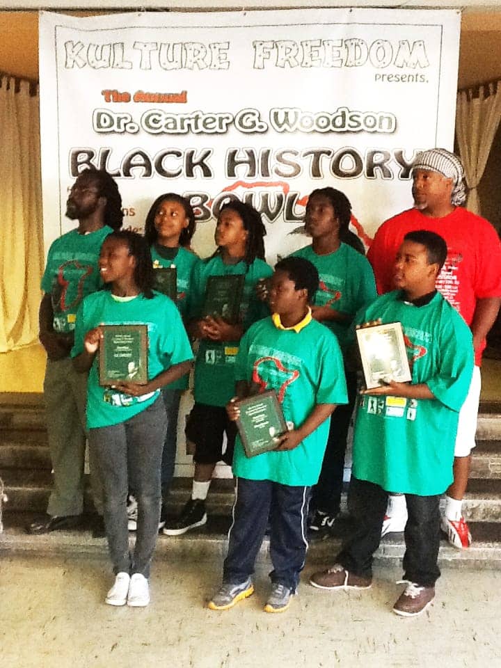 Dr.-Carter-G.-Woodson-Black-History-Bowl-middle-school-div.-winners-Ile-Omode-College-Prep-coach-Baba-Jahi-Yafeu-in-red, The Dr. Carter G. Woodson Black History Bowl is Feb. 22 at Frick Middle School in Oakland, Culture Currents 