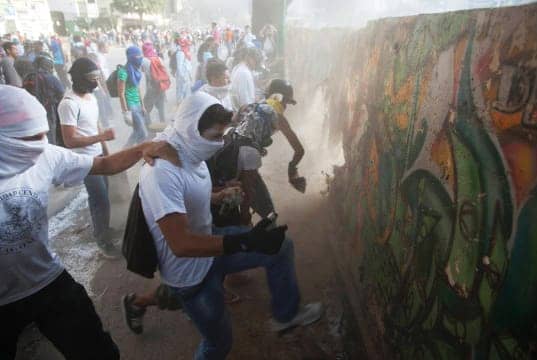 Venezuela-anti-gov-protesters-destroy-mural-wall-for-rocks-to-throw-0214-by-Rodrigo-Abd-AP, What is happening in Venezuela?, World News & Views 